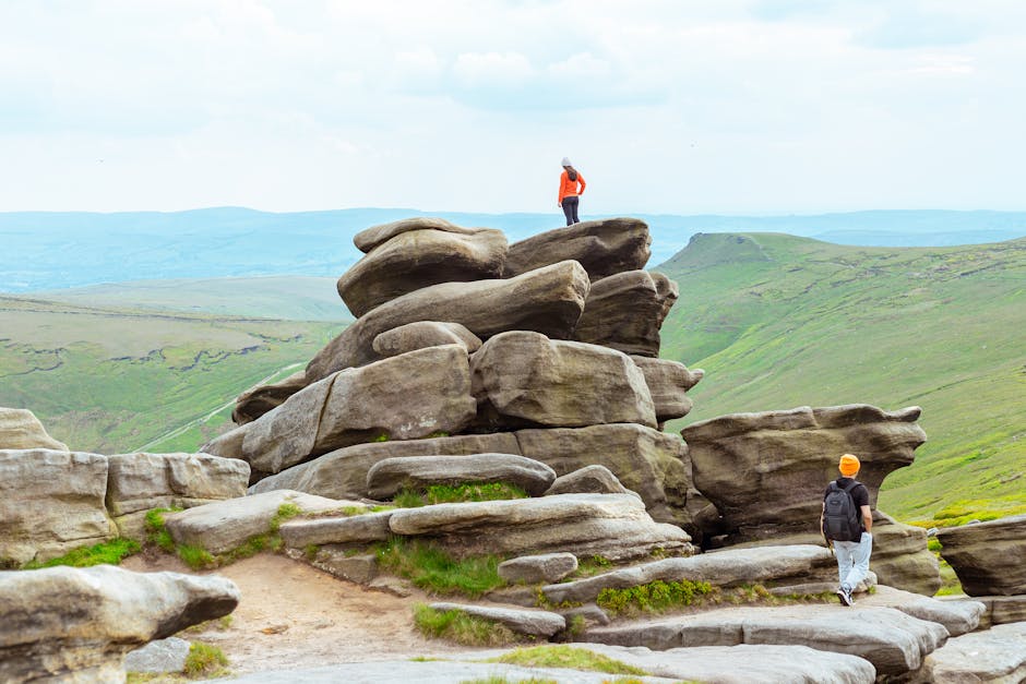 Peak District - hikers exploring rocky Kinder Scout terrain